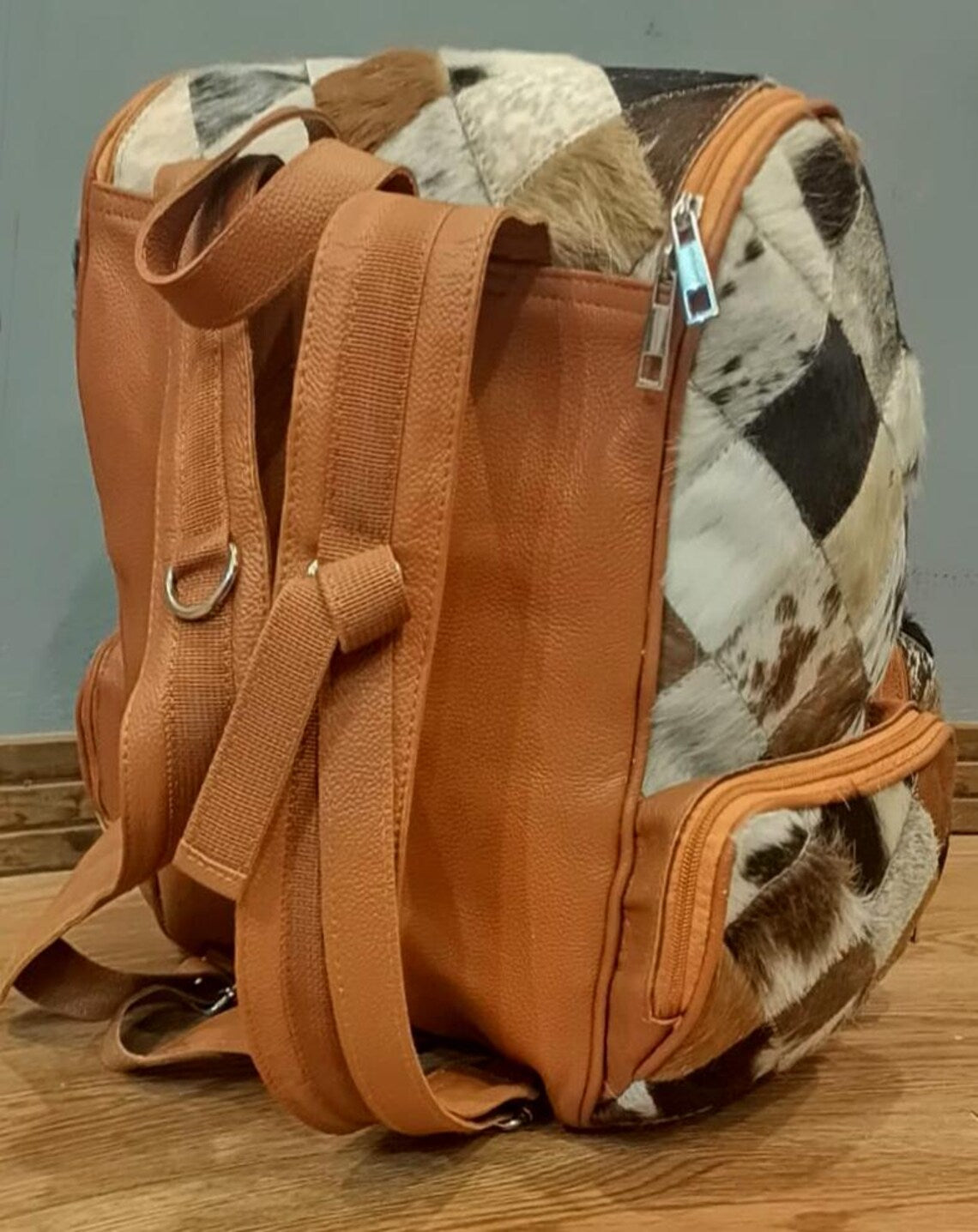 Unique pattern cowhide backpack for weekend trips, cowhide backpack back image.